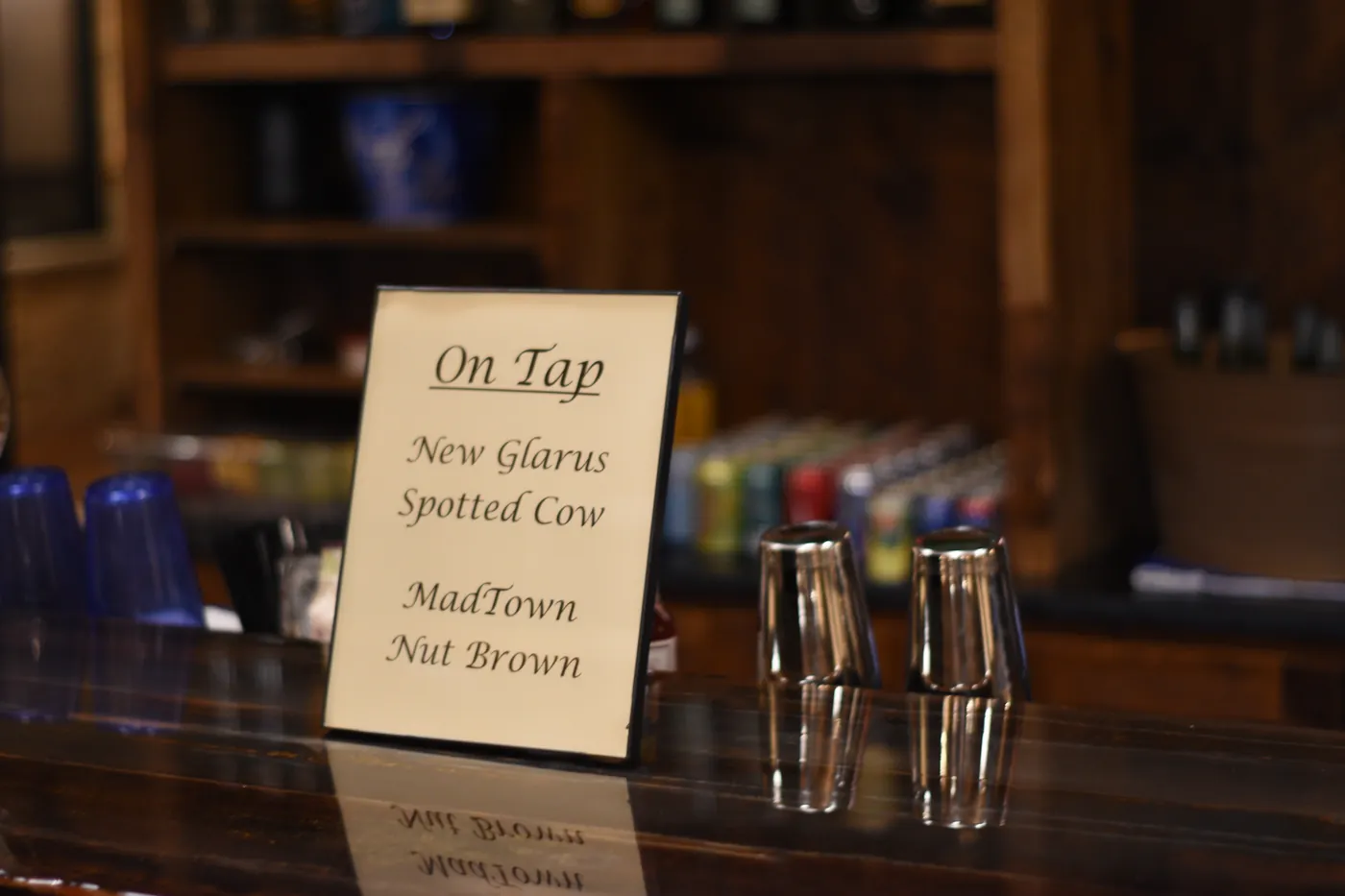 An On Tap sign for local Wisconsin beers on the bar