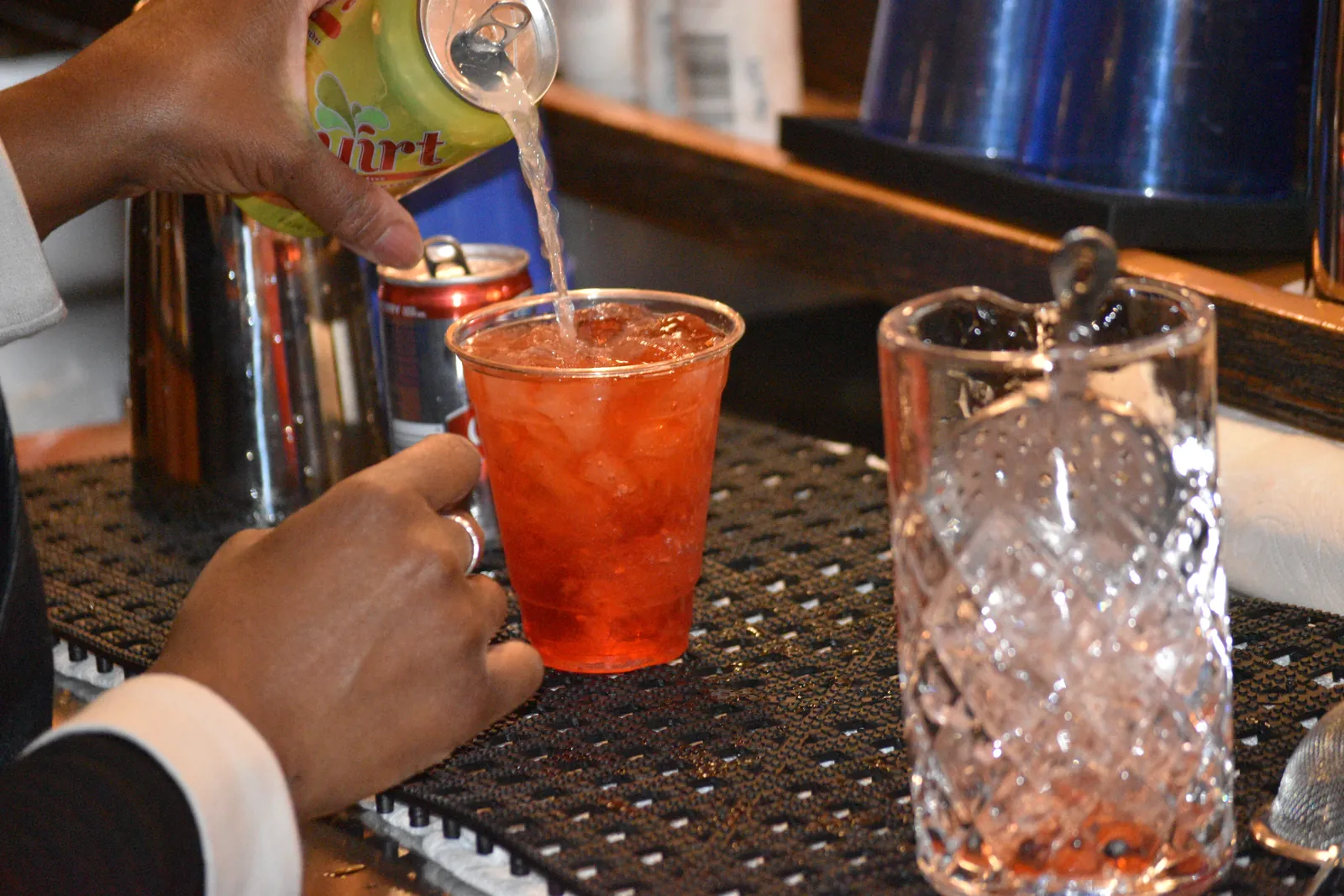 A signature cocktail poured over ice at the bar